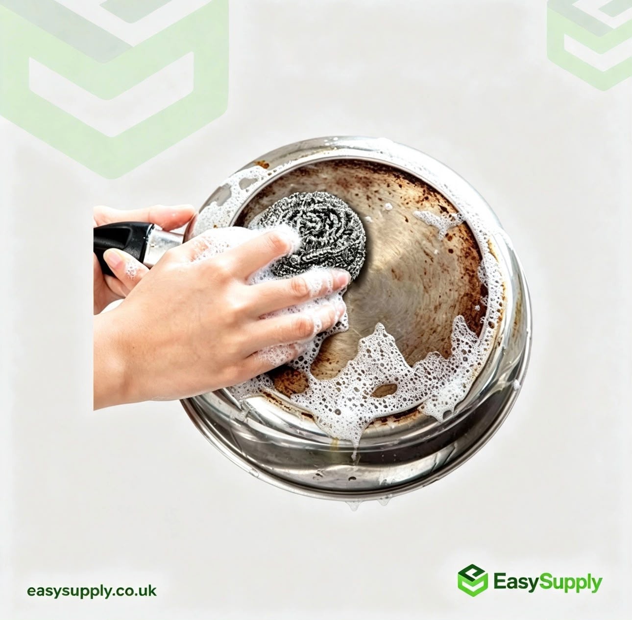Stainless steel scourer cleaning a pan